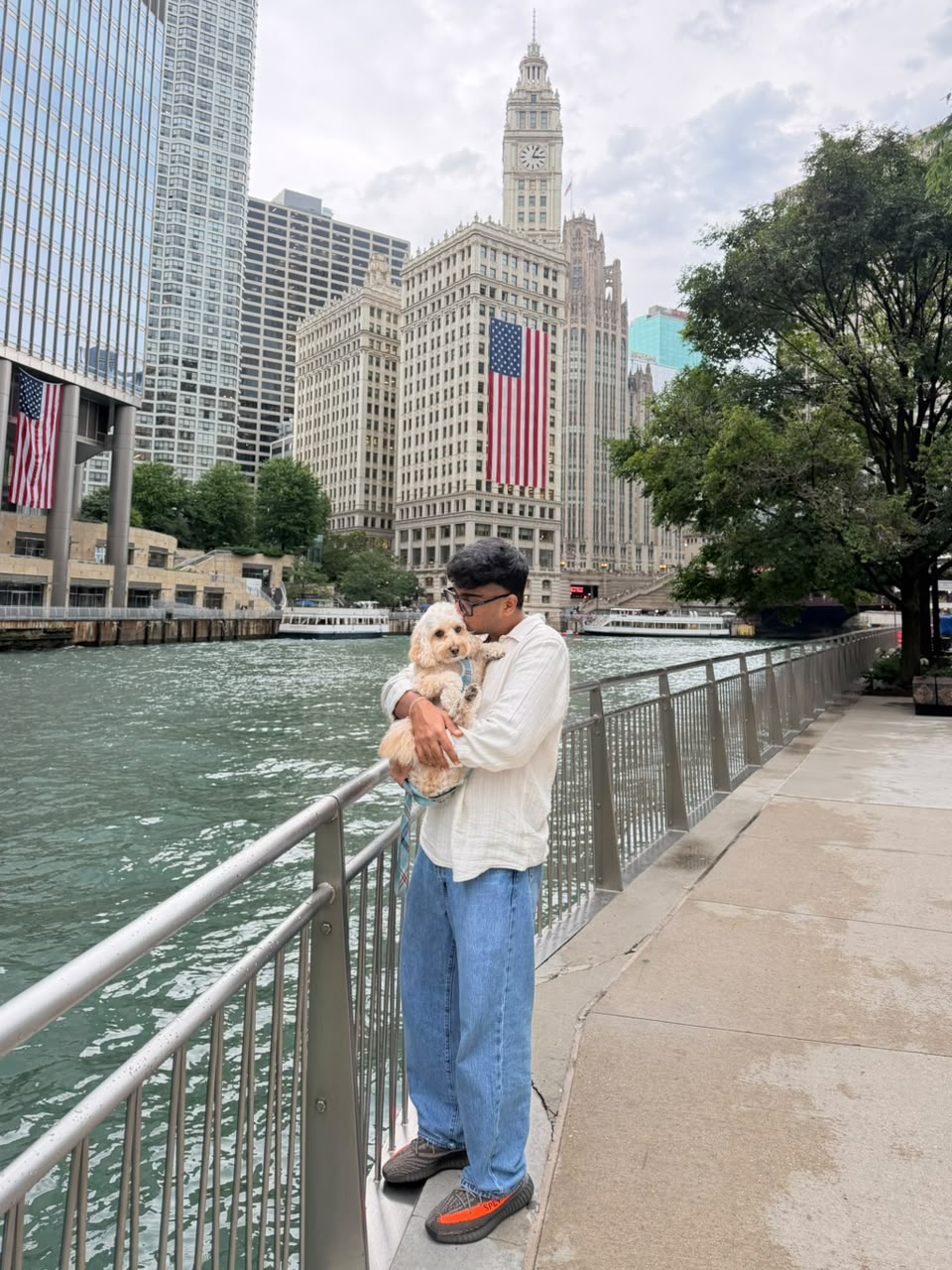 Dev Mehta holding his dog Harvey on the Chicago Riverwalk